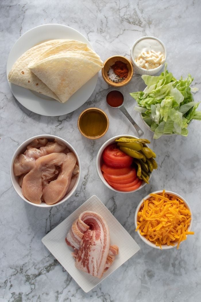 a top down view of all the ingredients required to make these bacon chicken wraps